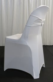 White pippee plastic chair dressed in a white spandex cover with matching bling ribbon, for hire in Brisbane.