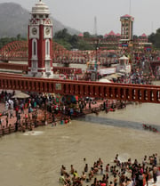 a crowd of people standing around a clock tower