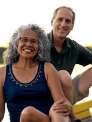 a smiling, middle aged couple