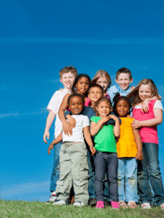 A colorful group of children standing on a hilltop