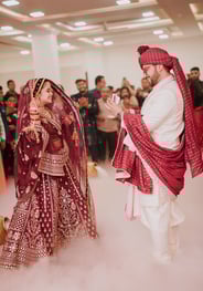 a man and woman in traditional indian wedding attire