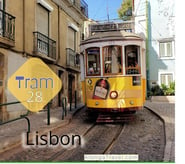 Cute looking yellow tram waiting on a stop in Lisbon & a sign that says 'Tram 28'