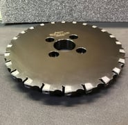 a circular saw blade saw blade sawdusted on a table