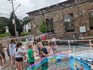 a group of children playing with bubbles at a library