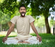 a man with a tongue sticking out of his tongue doing yoga to boost immunity