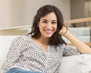 a woman sitting on a couch with her legs crossed