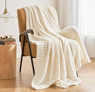 a chair with a blanket on it and a throw blanket 