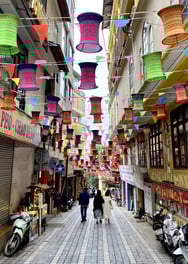 a couple of people walking down a street