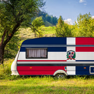 Camping in the Dominican Republic with a DR-flag camper in lush green nature