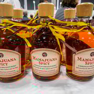 Bottles of Dominican Mamajuana Spicy on display at local market or festival
