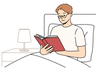 a man reading a book in bed with a lamp on the side