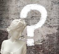 a white marble busturine with question mark on it