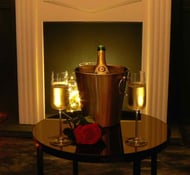 coupes à champagne devant feu de cheminée et rose 