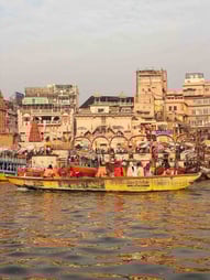Group of Indians on a boat ride along the Ganges River in Varanasi, India.