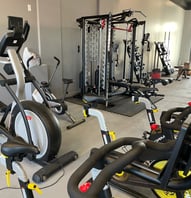 a gym room with a variety of exercise equipment