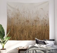 Wall tapestry hanging on a bedroom wall with bed underneath it and bedding on bed
