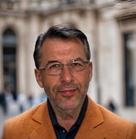 Jan, Founder and Chief Financial (CFO) of Weihs International, in an blazer with an urban backdrop.