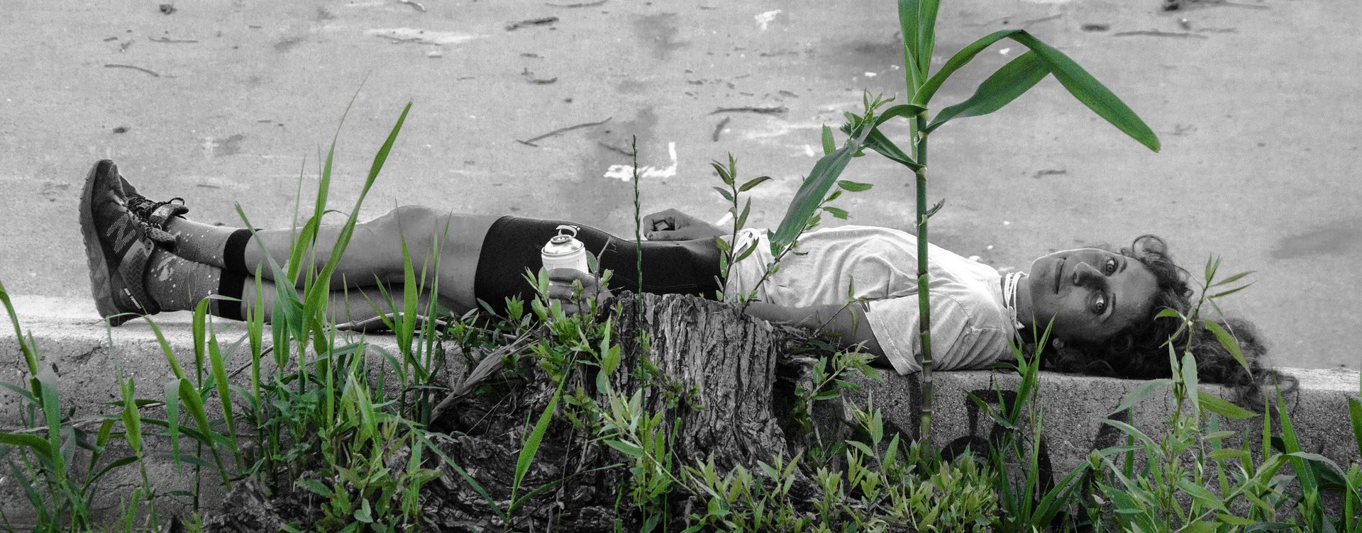 person laying horizontally among bamboo growth rhizomatic structure in LA River