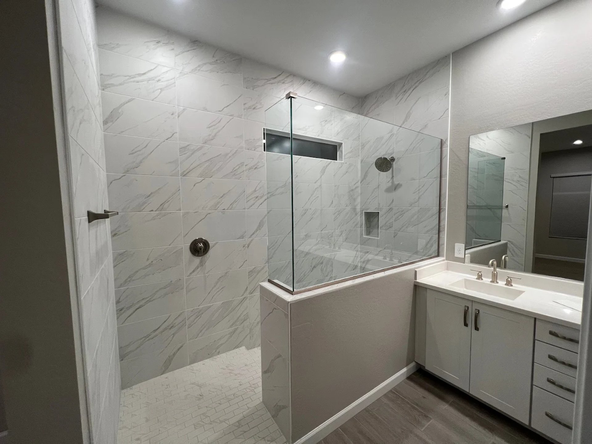a large kitchen with a center island and marble counter tops
