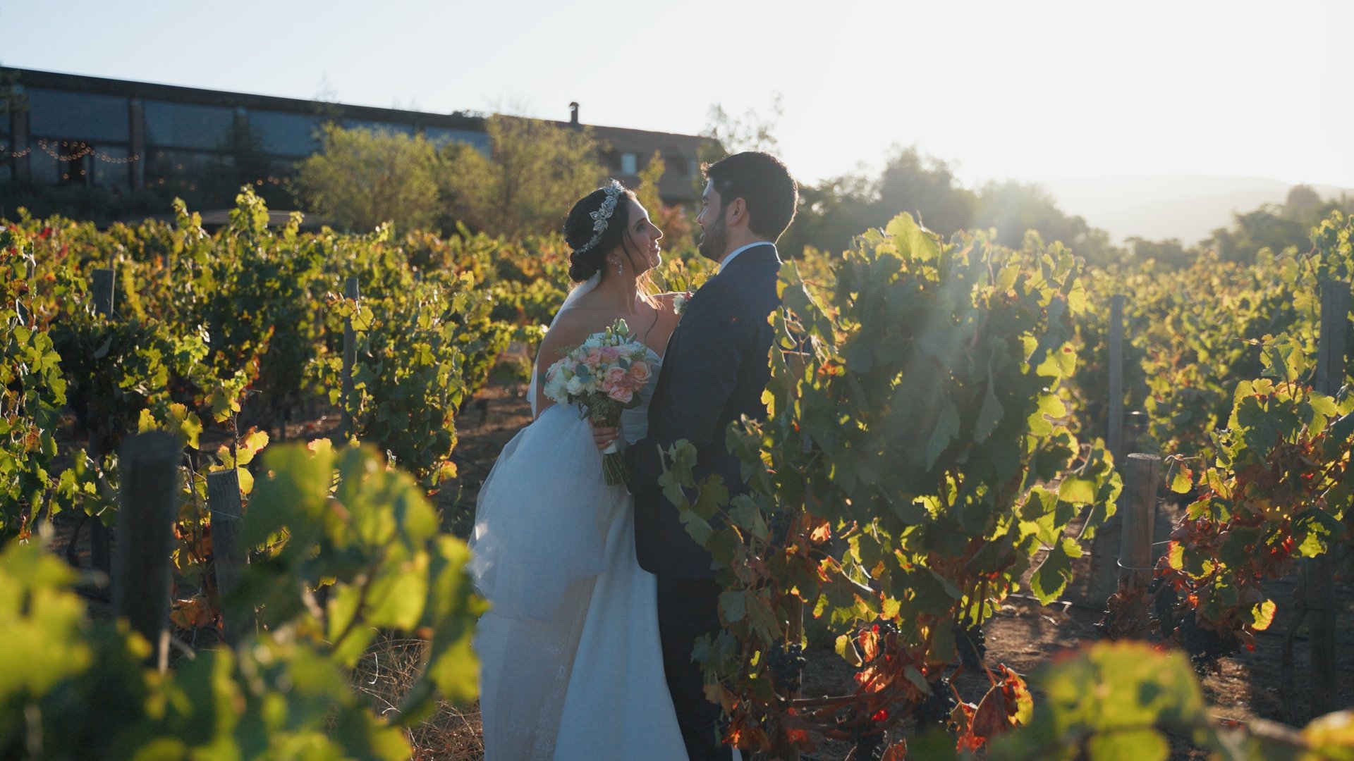 A man and a woman standing in a field of tall grass