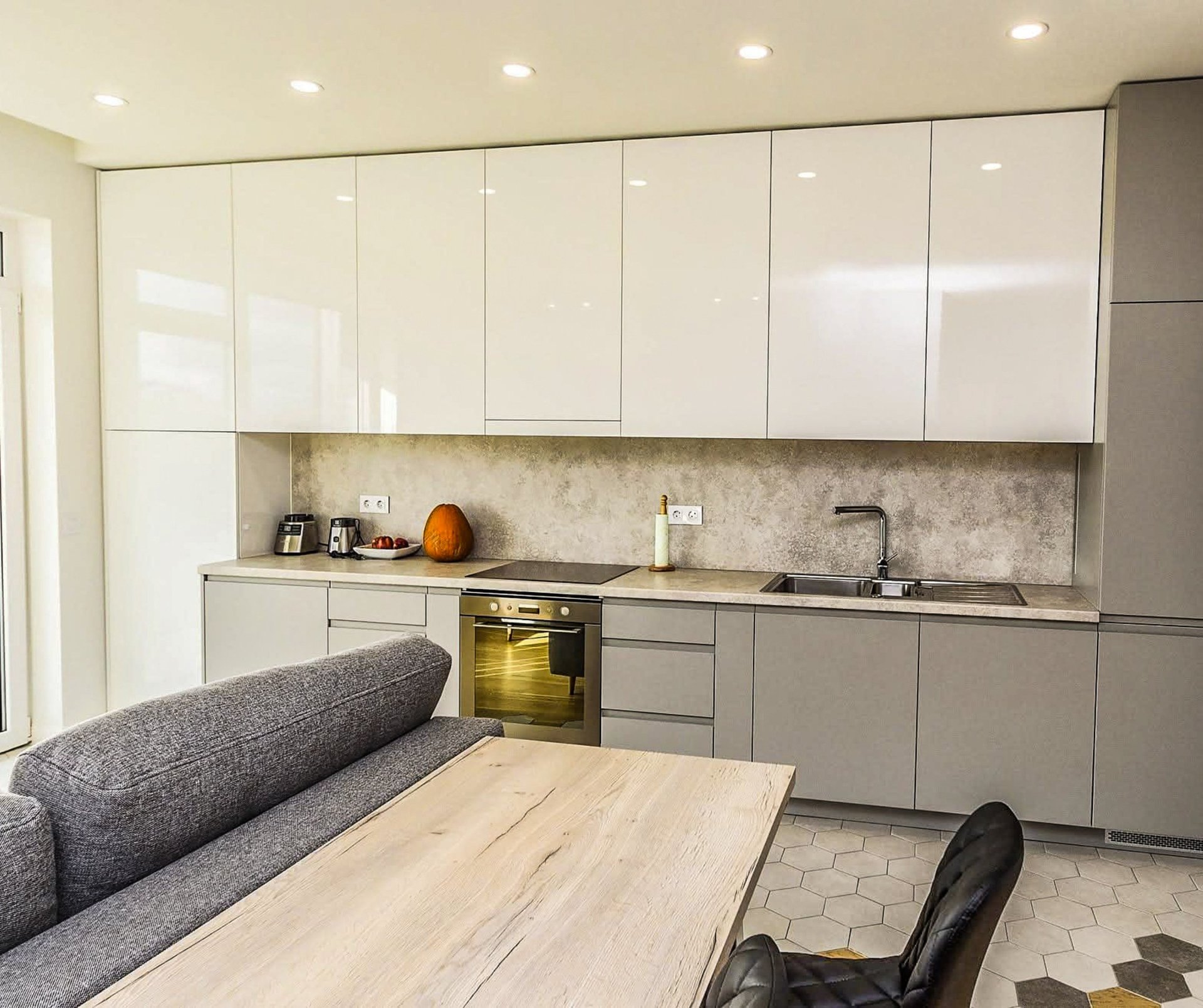 a modern kitchen with a bar and stools
