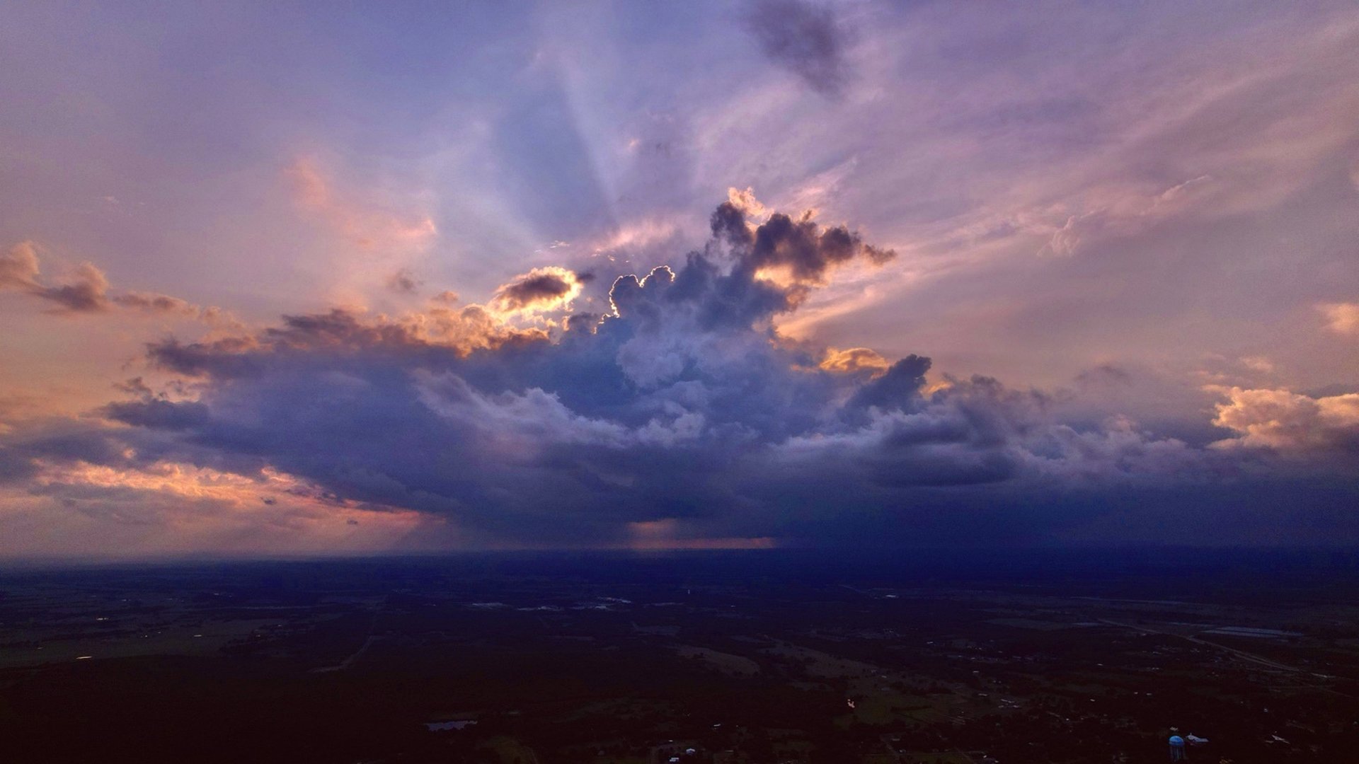an abstract photo of a curved building with a blue sky in the background
