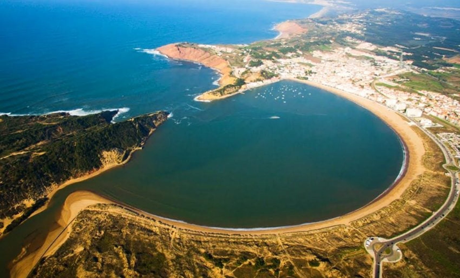 person riding on skis during winter surrounded by mountains