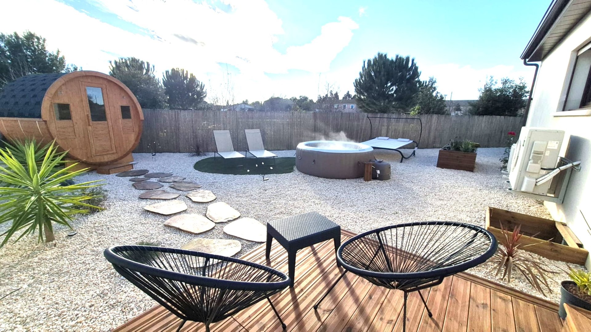 woman sitting on poolside setting both of her feet on pool