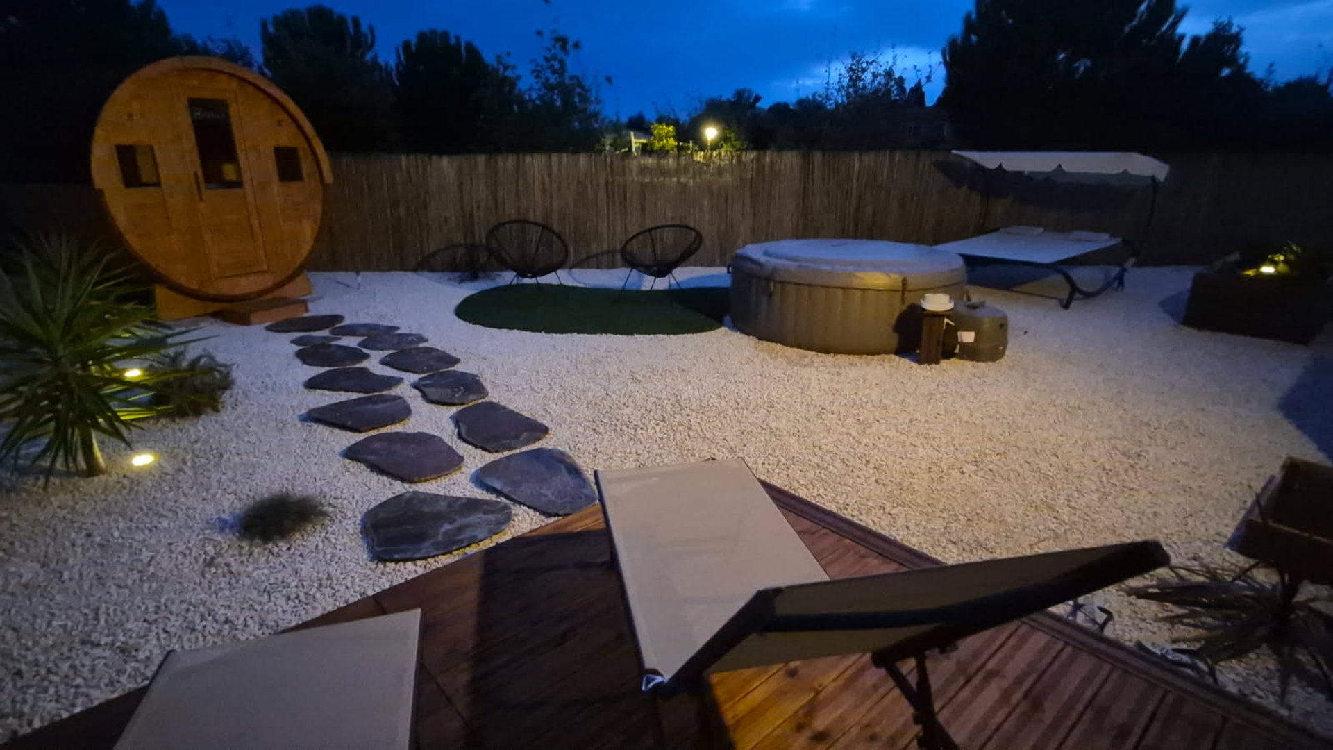 woman sitting on poolside setting both of her feet on pool
