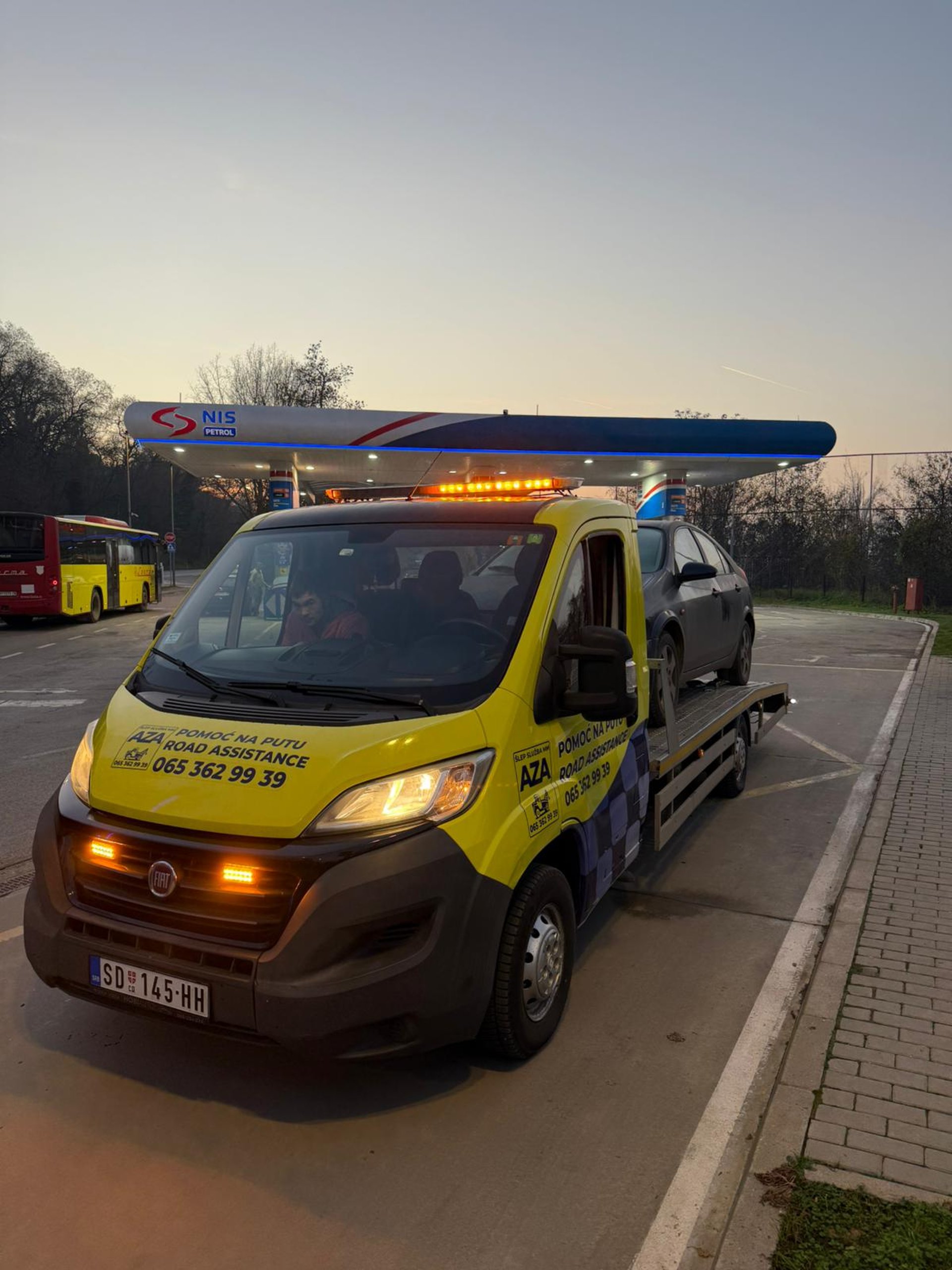 gray asphalt road between green grass field under blue sky during daytime