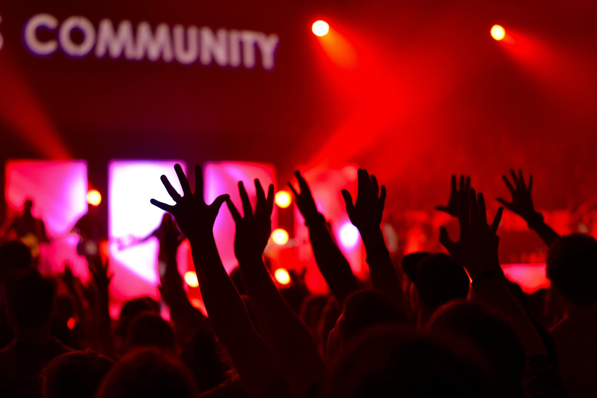 a stage with a laptop and microphone in front of a crowd