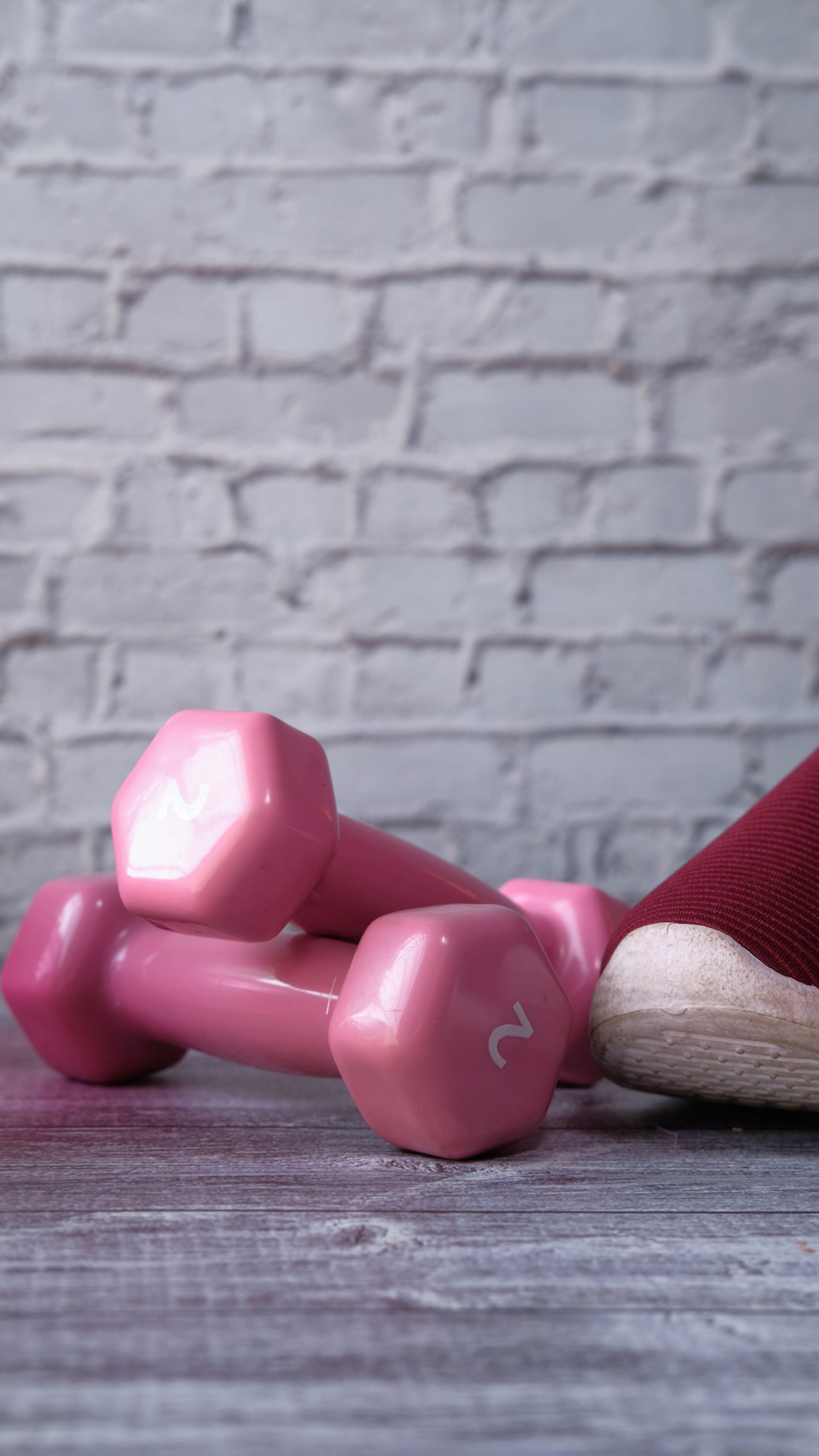 pink dumbbell on pink textile