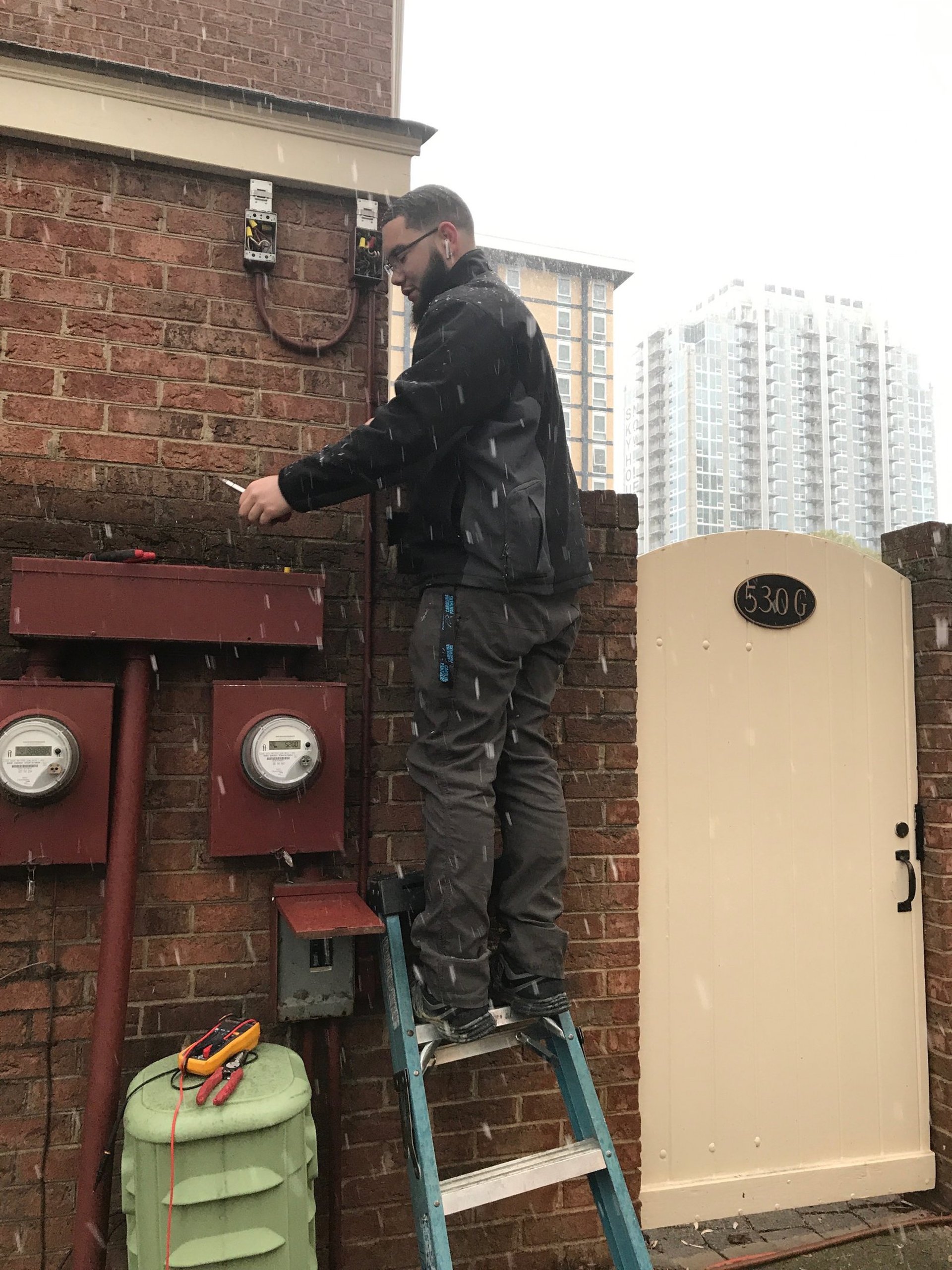 man on top of electrical wires