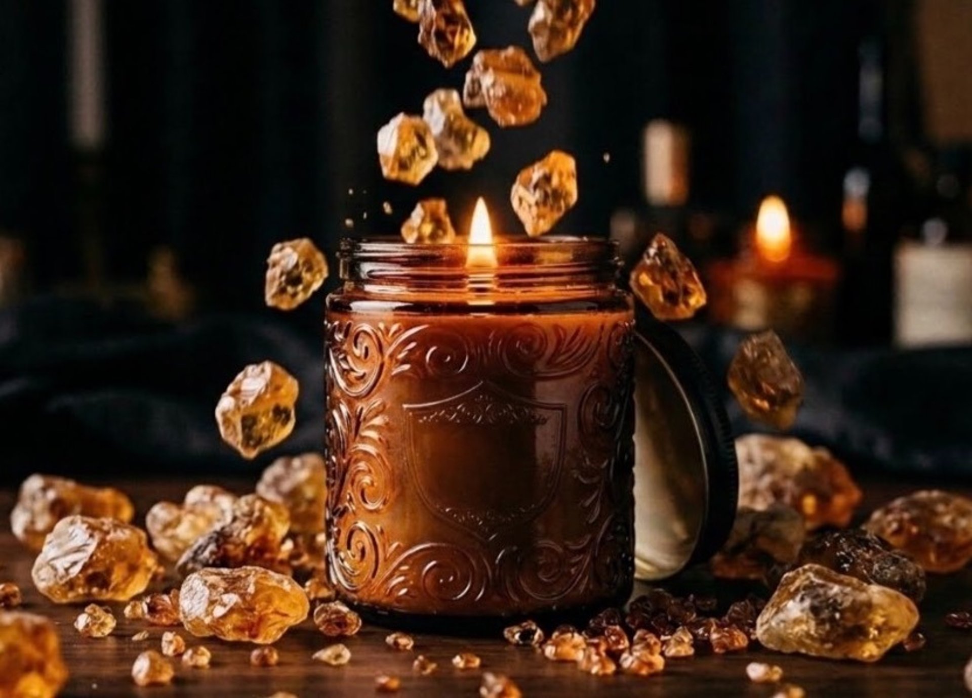 orange candle in clear glass jar