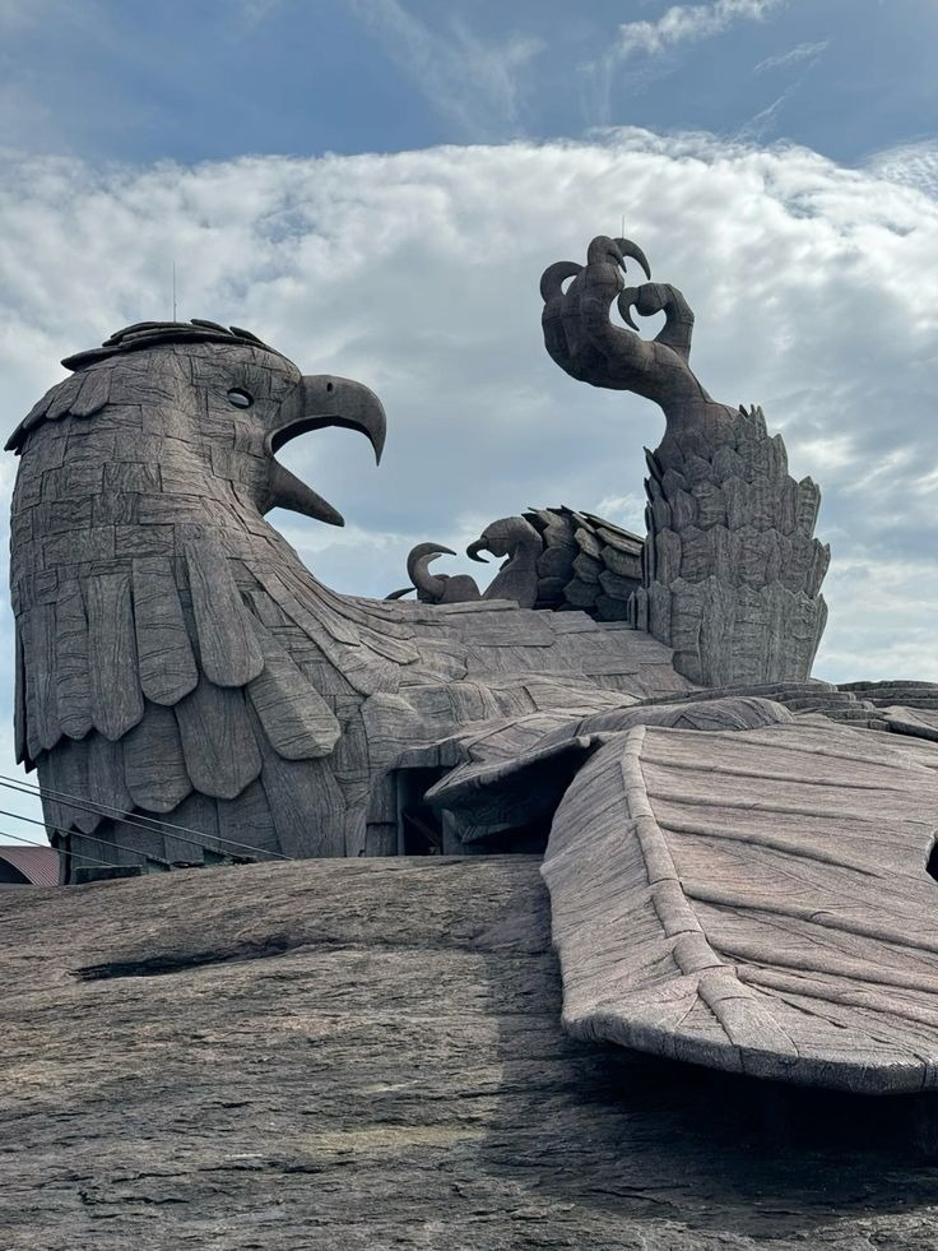 an abstract photo of a curved building with a blue sky in the background