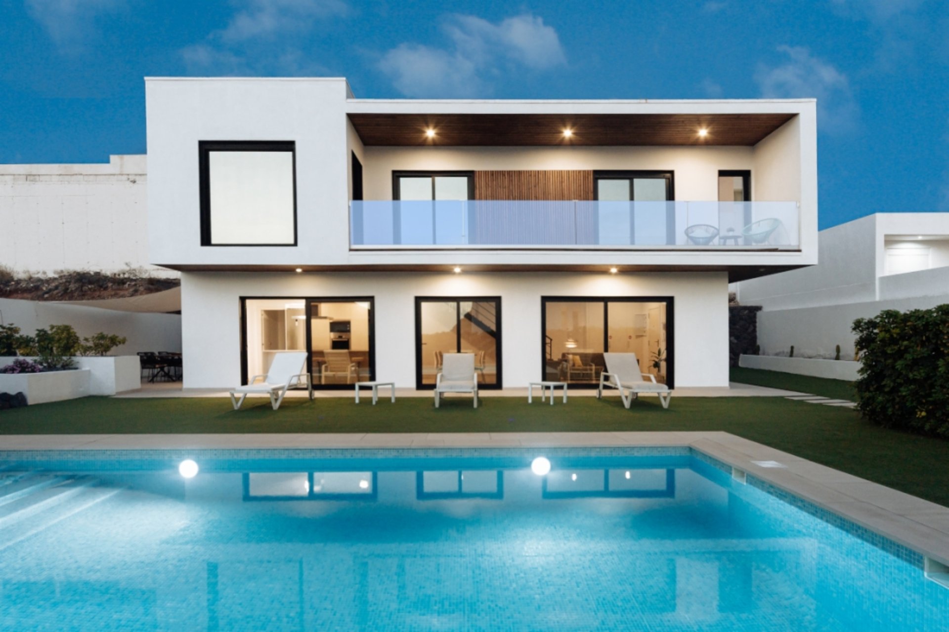 an abstract photo of a curved building with a blue sky in the background