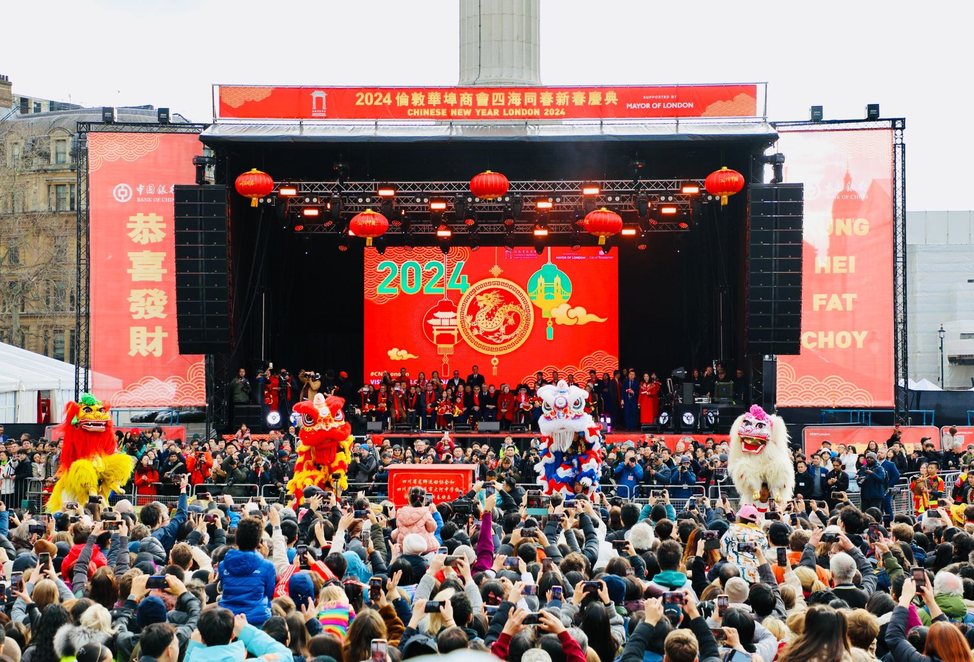 a group of people walking down a street under red lanterns