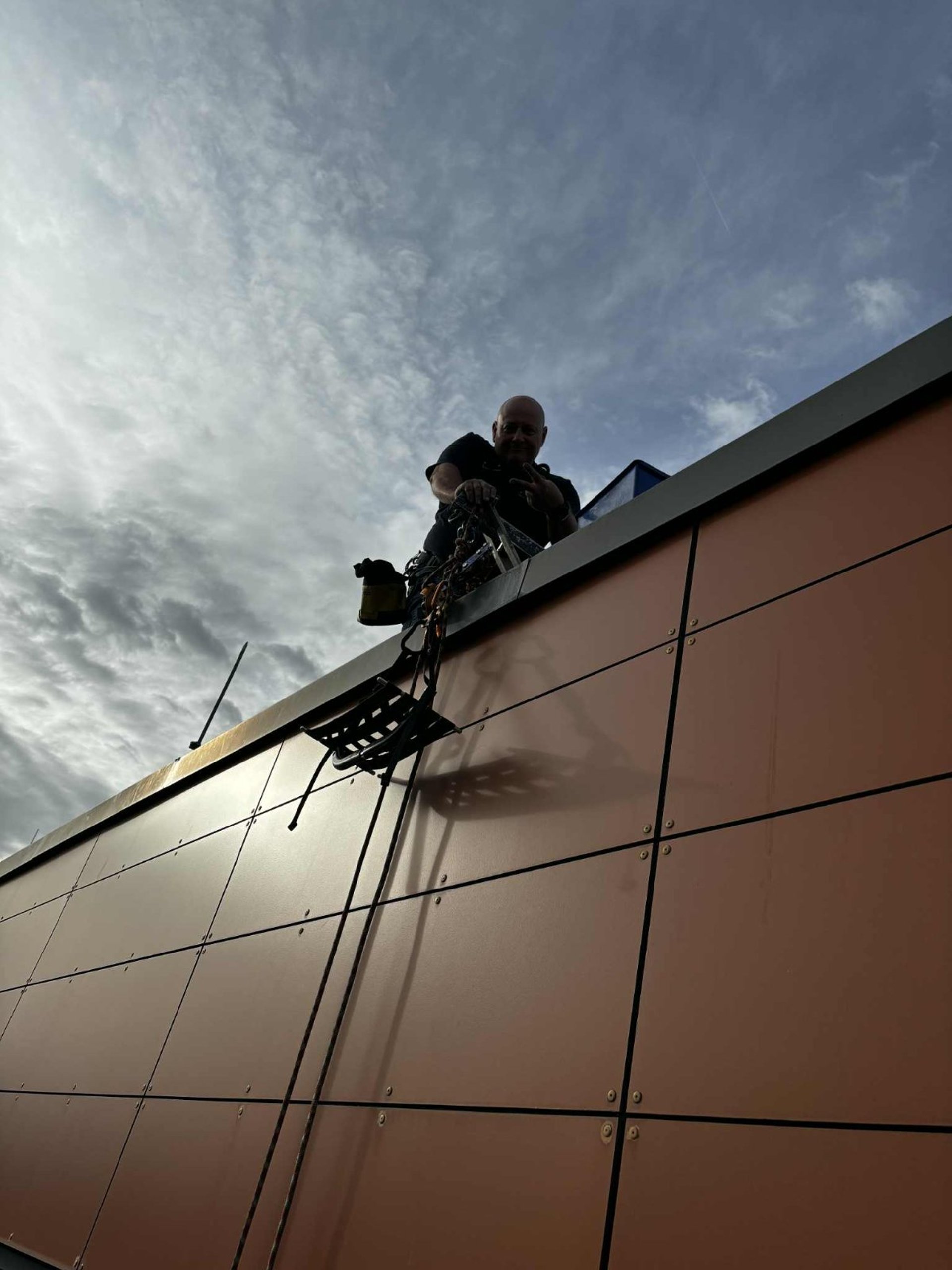 an abstract photo of a curved building with a blue sky in the background