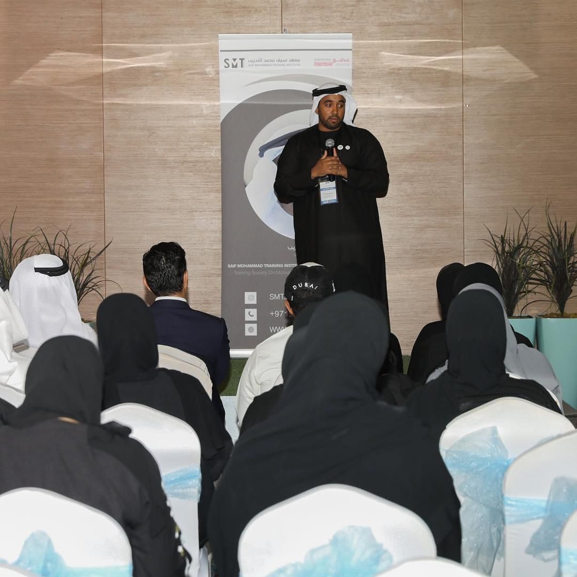 a silhouette of a man standing in front of a crowd