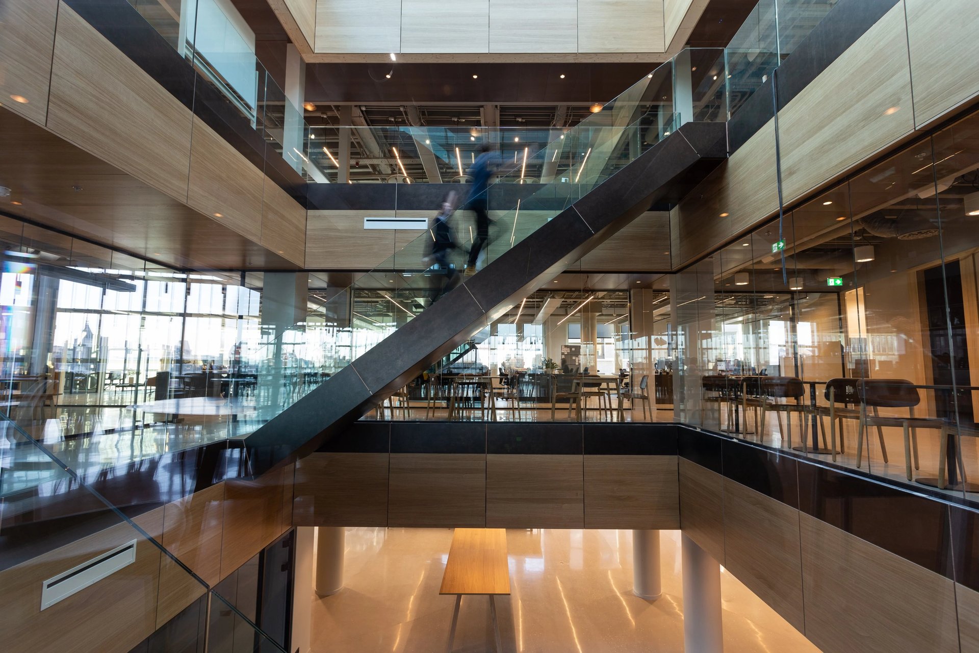 three men sitting on chair beside tables