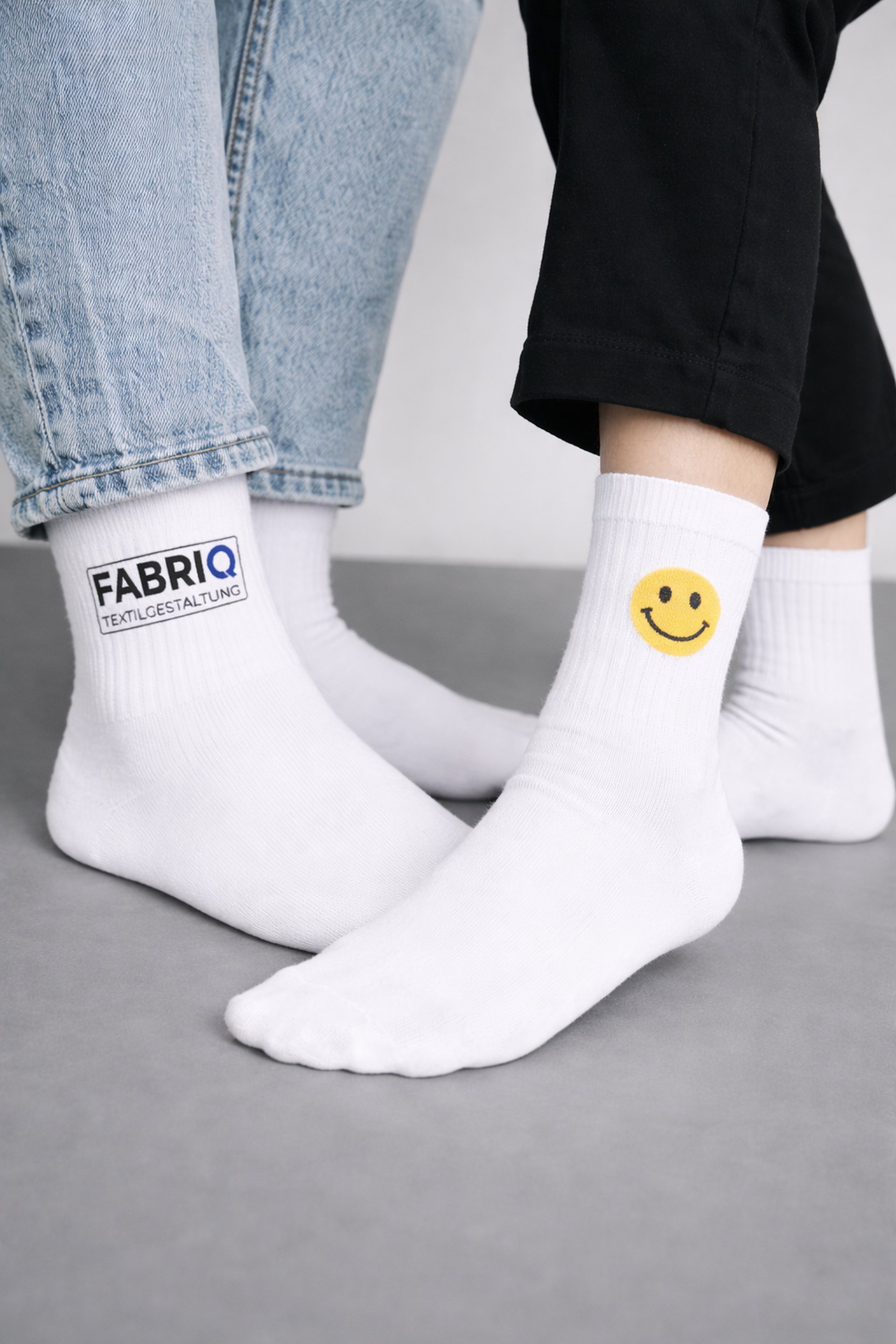 A person holding a pair of socks in their hand