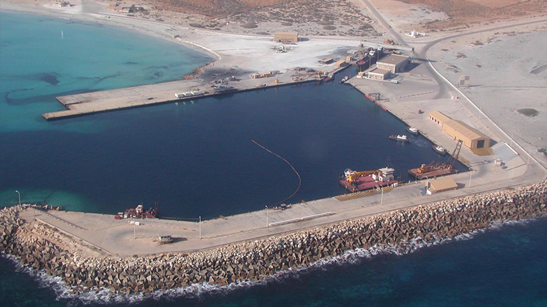 an abstract photo of a curved building with a blue sky in the background