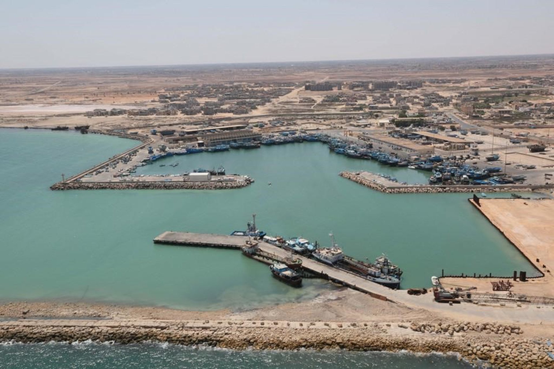 an abstract photo of a curved building with a blue sky in the background