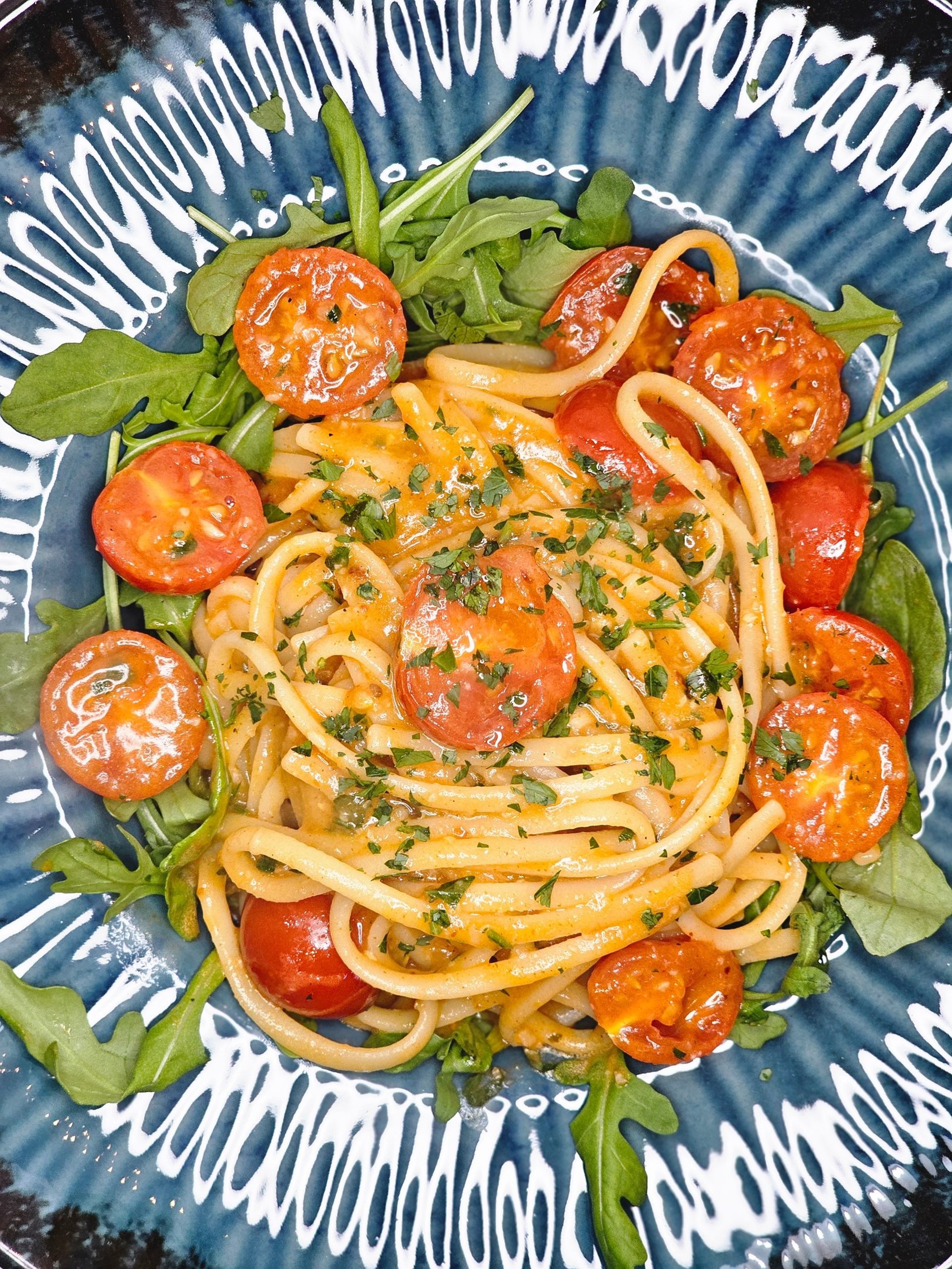 a city street filled with lots of traffic next to tall buildings