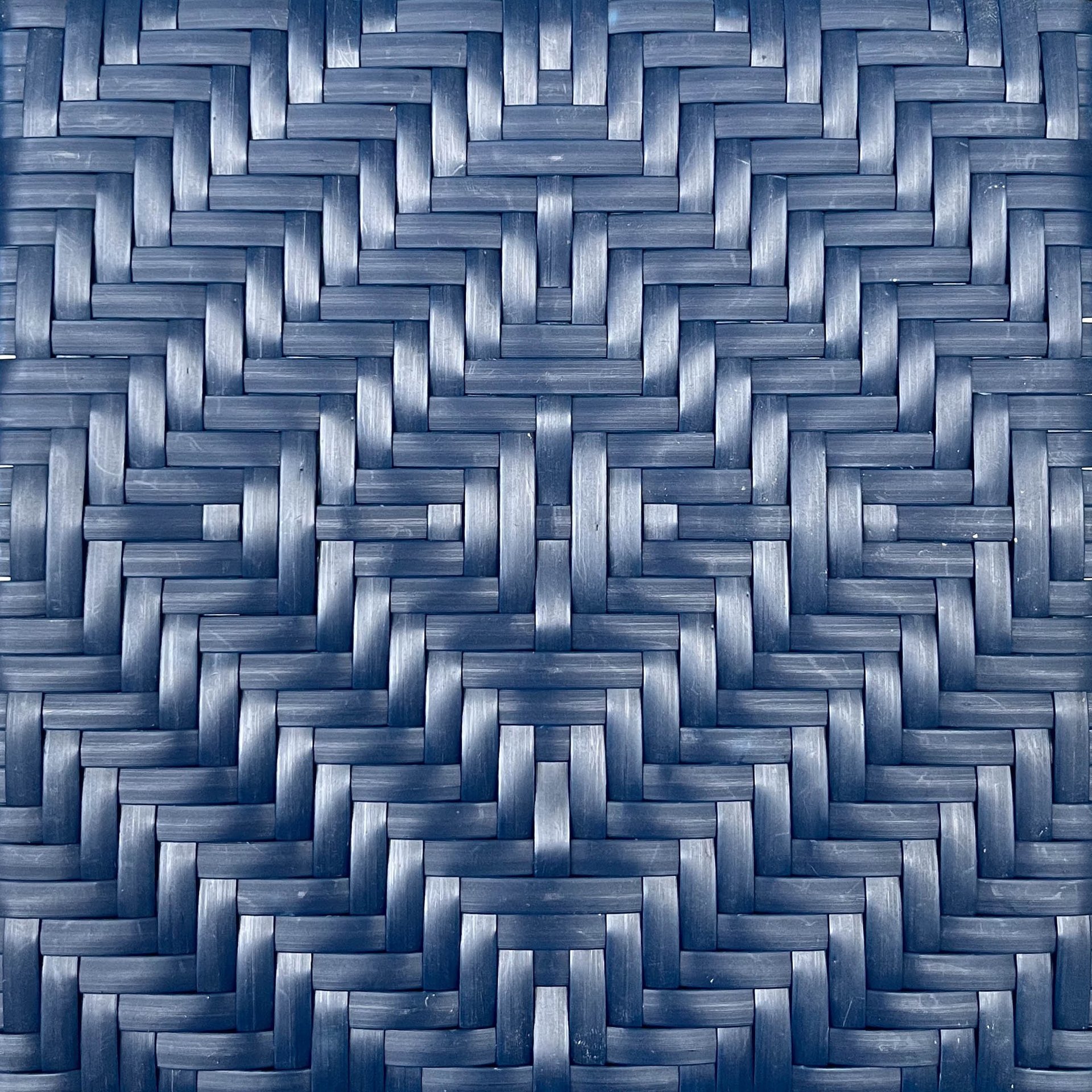 an abstract photo of a curved building with a blue sky in the background