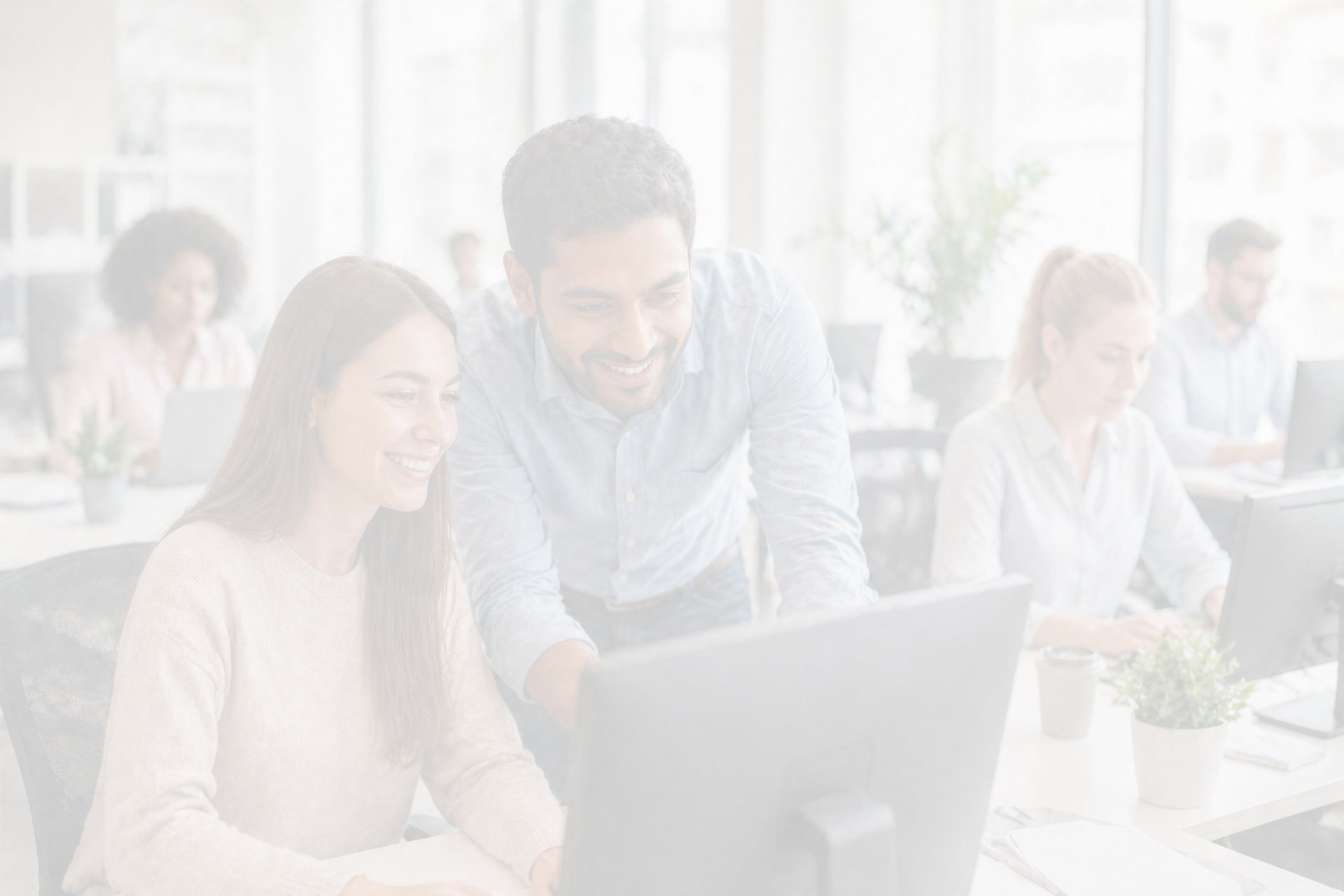 woman and man sitting in front of monitor
