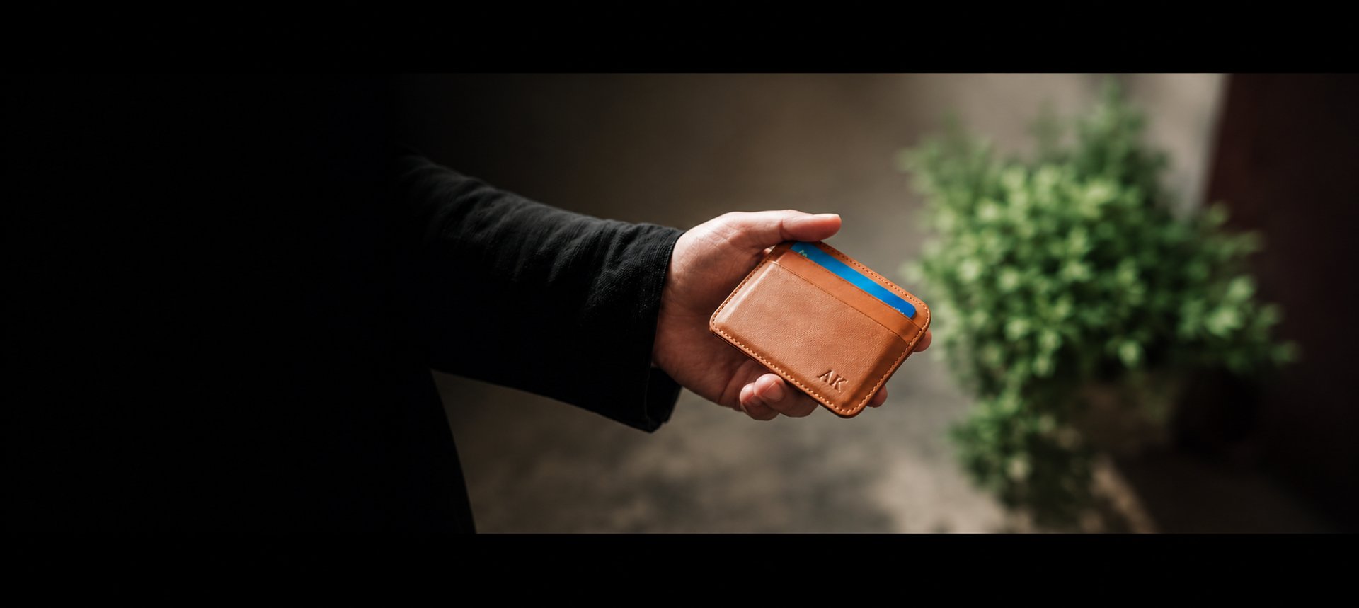 a person holding two wallets in their hands