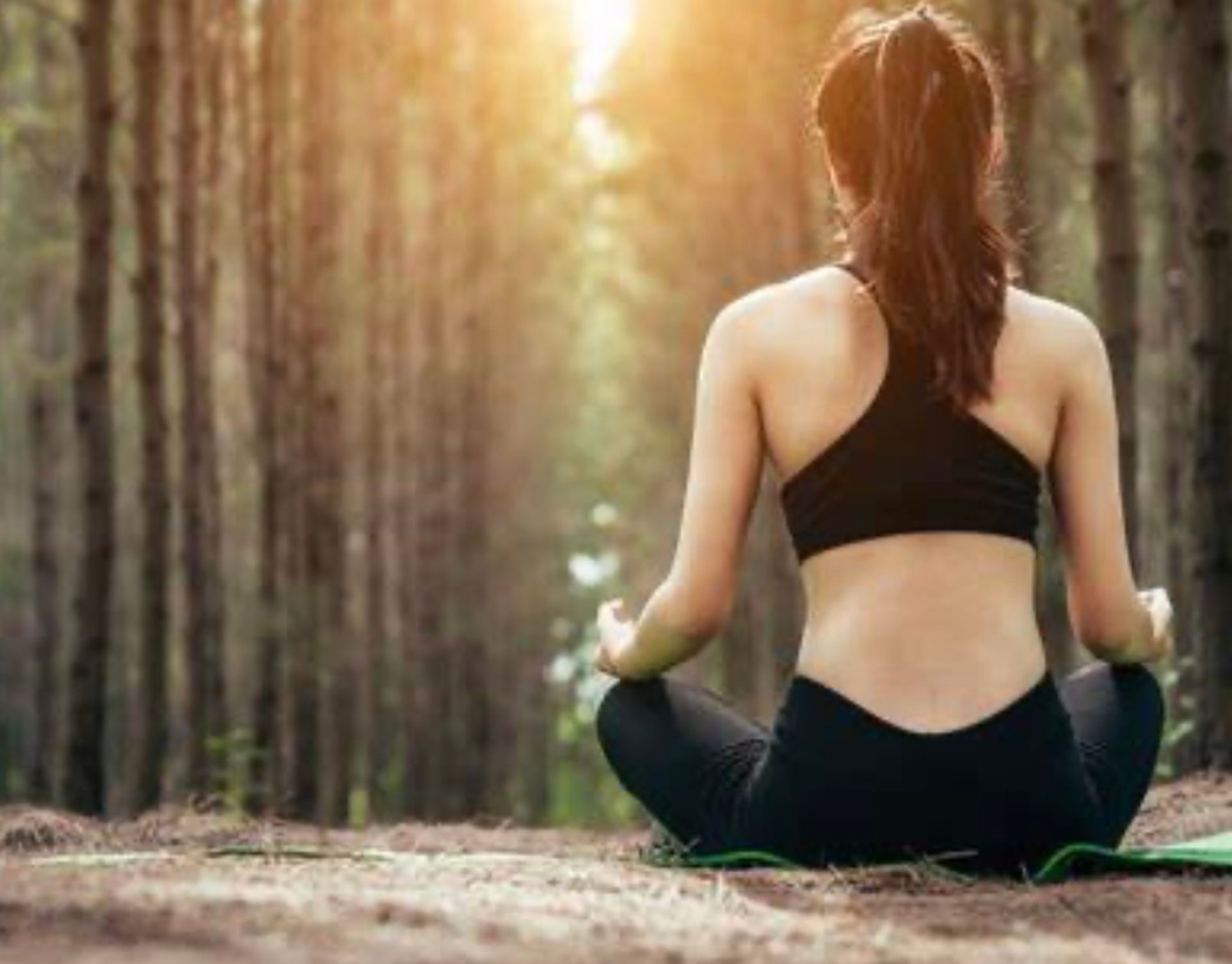 woman in black tank top and black shorts raising her hands