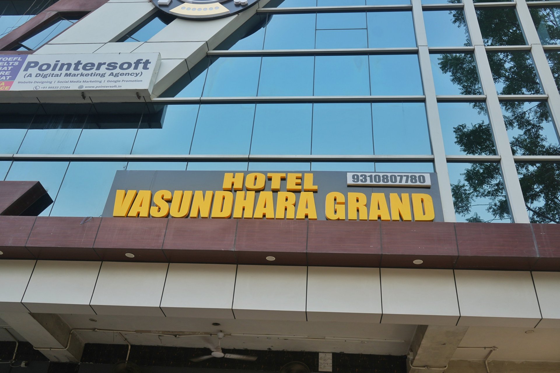 low-angle photo of Hotel lighted signage on top of brown building during nighttime