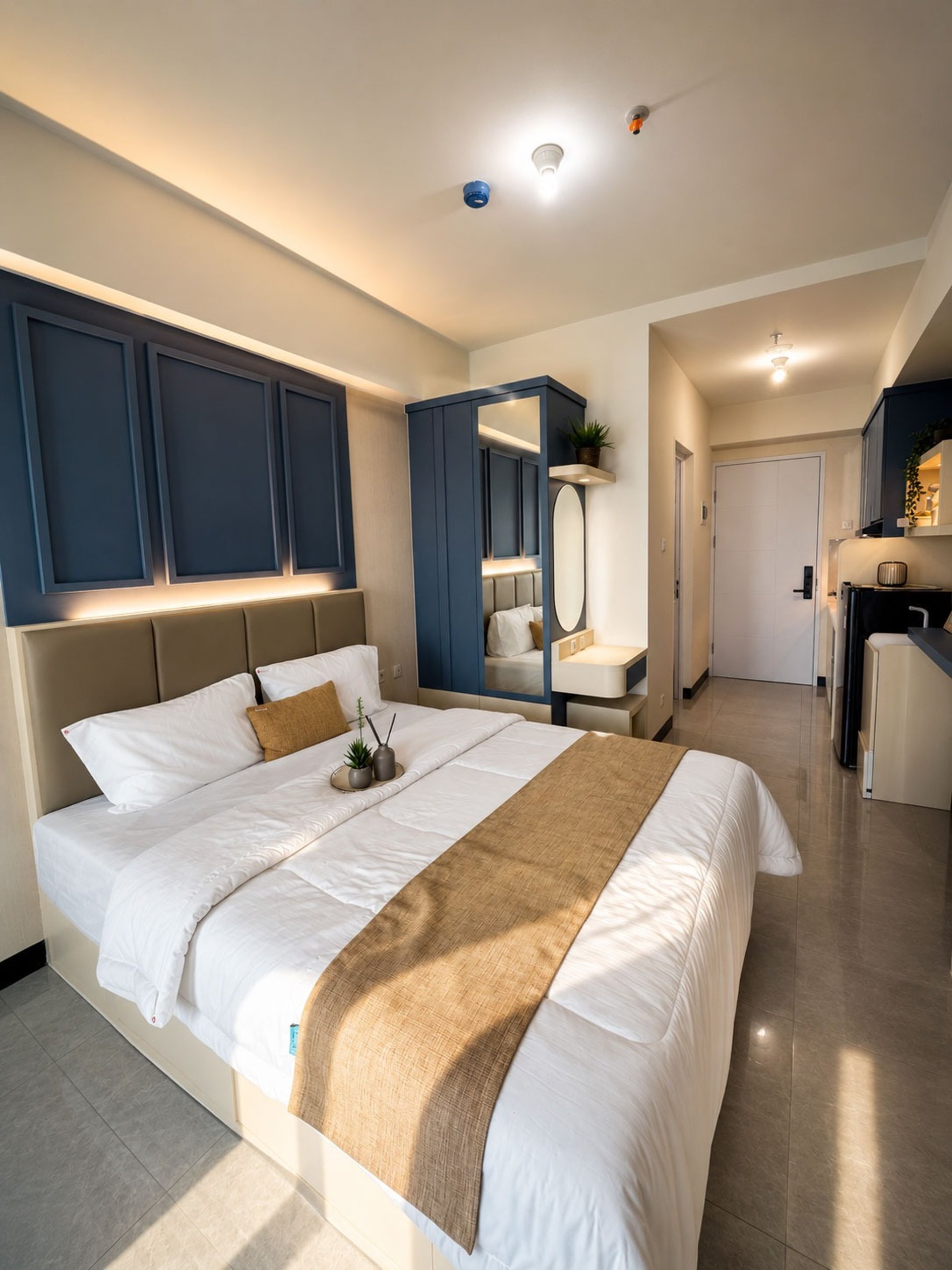 a bedroom with blue walls and a white bed